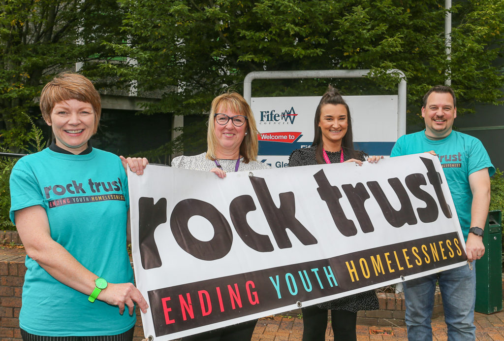 Rock Trust employees holding banner